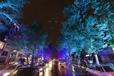 Cars on illuminated street at night