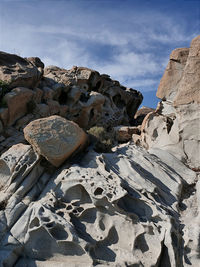 Low angle view of rock formation on beach against sky