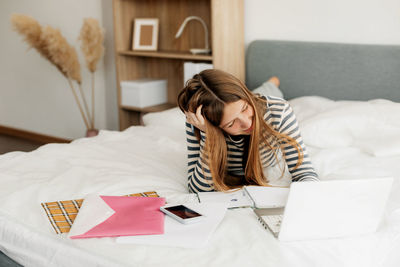 Portrait of young woman using digital tablet on table