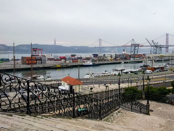 Boats moored at harbor against clear sky