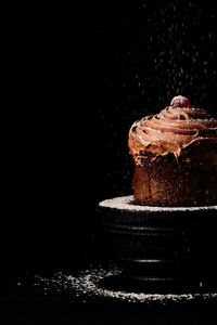 Close-up of chocolate cake against black background