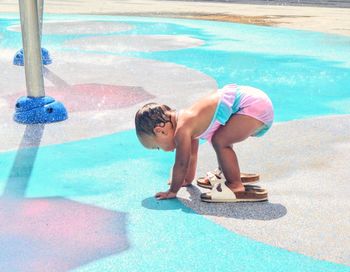 Girl bending at fountain