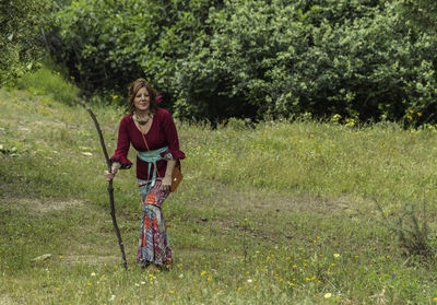 Full length of woman walking on grassy land