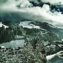 Snow covered mountain against cloudy sky