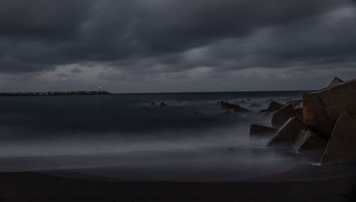 Scenic view of sea against storm clouds