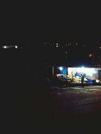 View of illuminated road at night