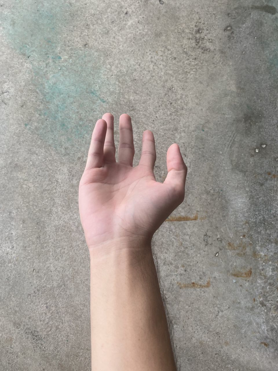 CLOSE-UP OF PERSON HAND ON WALL