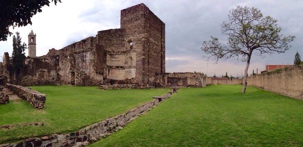 Low angle view of castle against cloudy sky