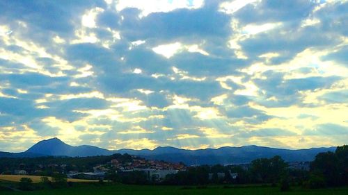 Scenic view of mountains against cloudy sky