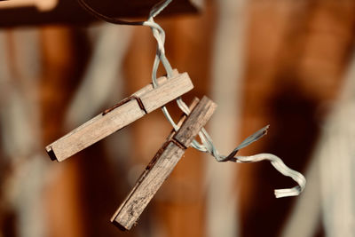 Close-up of cross hanging on wood