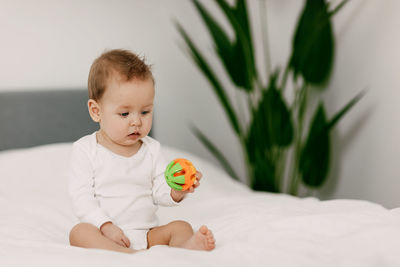 Boy with toy on bed