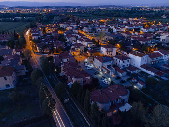 High angle view of illuminated buildings in city at night