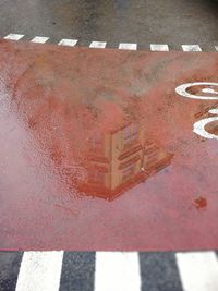 High angle view of text on puddle