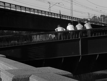 Man standing on bridge