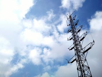 Low angle view of telephone pole against sky