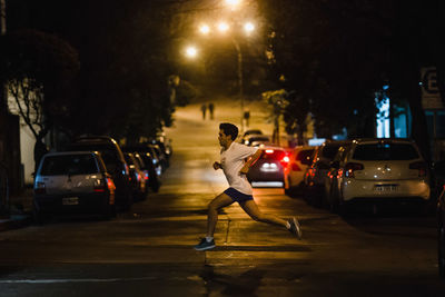Woman running on road at night