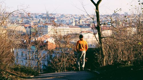Rear view of man looking at cityscape