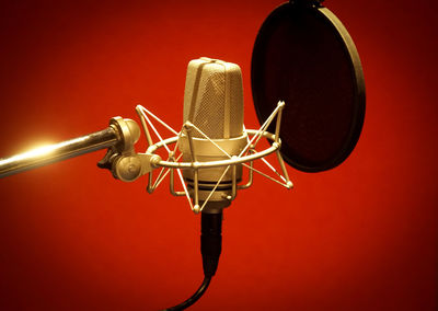 Close-up of microphone against red background