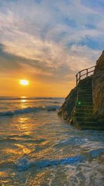 Stairs on the beach with sunset