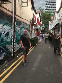 Rear view of man walking on street in city