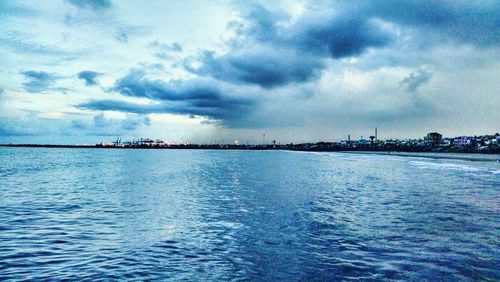 Scenic view of sea against cloudy sky