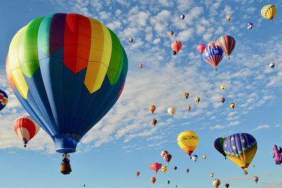 Low angle view of colorful hot air balloons against sky