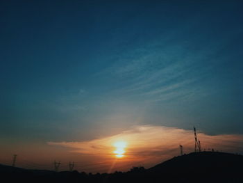 Scenic view of silhouette trees against sky at sunset