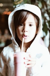 Close-up portrait of a girl drinking glass