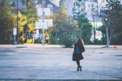 Full length rear view of woman walking