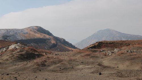 Scenic view of arid landscape against sky