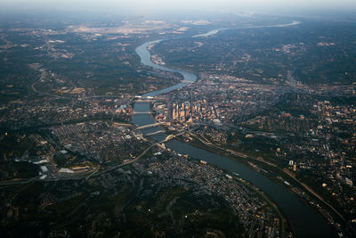 High angle view of illuminated city by river