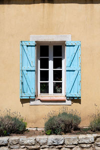 Low angle view of window on wall of building