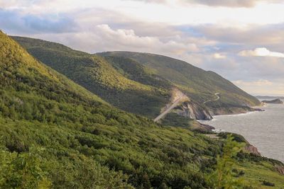 Scenic view of sea and mountains against sky