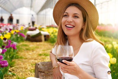 Woman day dreaming while holding wineglass