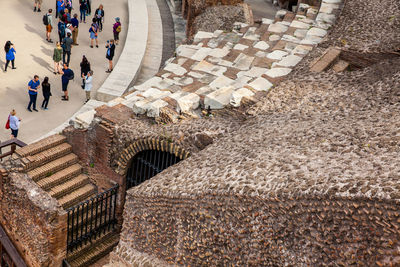 Tourists visiting the interior of the famous colosseum in rome