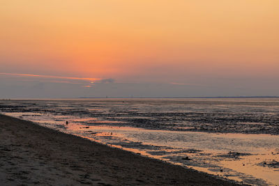 Scenic view of beach against sky during sunset