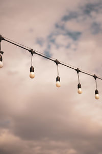 Low angle view of illuminated lamp against sky