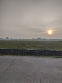 Scenic view of field against sky during sunset