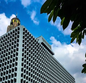 Low angle view of building against cloudy sky