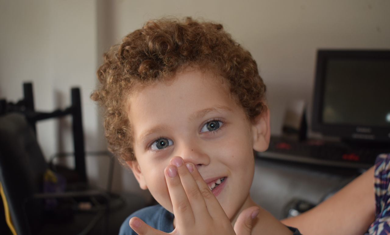 portrait, headshot, child, one person, childhood, front view, real people, looking at camera, indoors, home interior, lifestyles, focus on foreground, boys, males, men, cute, leisure activity, innocence