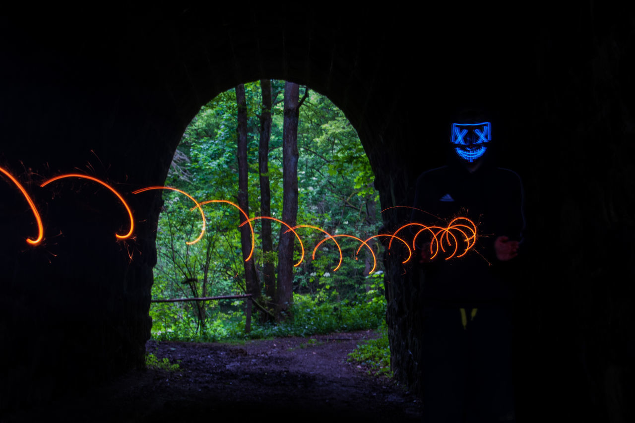 VIEW OF ILLUMINATED TUNNEL AT NIGHT