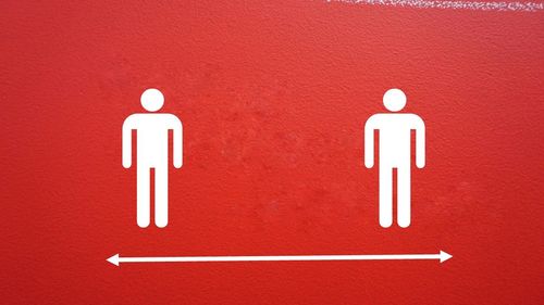 Close-up of sign on red wall