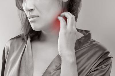 Digital composite image of woman suffering from neckache