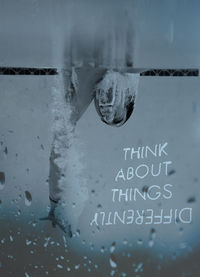 Close-up of text on glass window