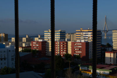 Buildings in city against clear sky