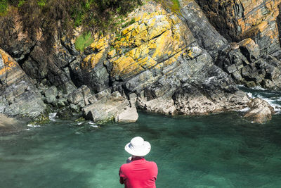 Rear view of woman standing on rock formation