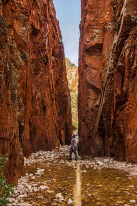 Man standing amidst rock formation