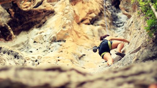 Full length of woman standing on rock formation