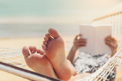 Low section of woman lying on floor