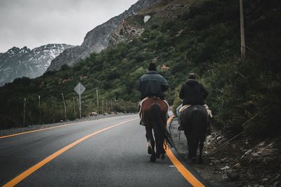 Rear view of people on road